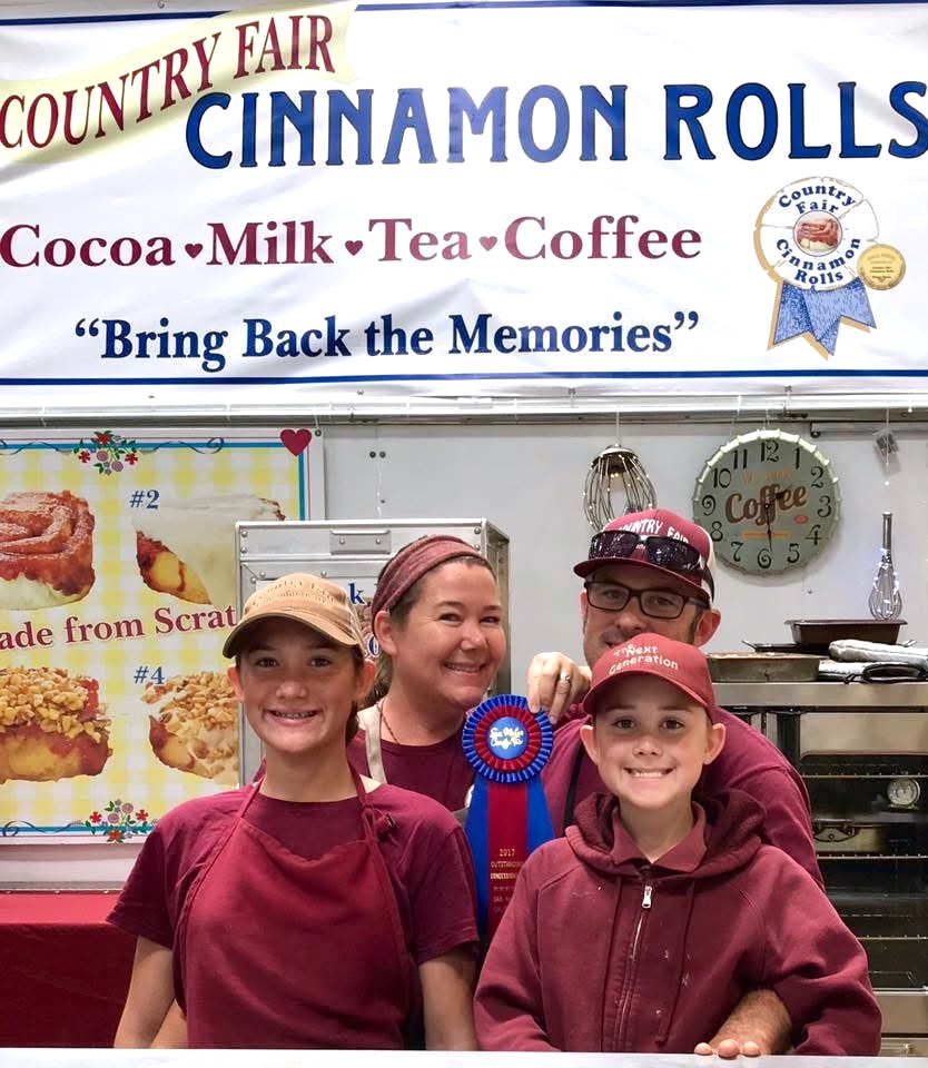 Mother father and two sons - in uniform in front of the cinnamon roll truck